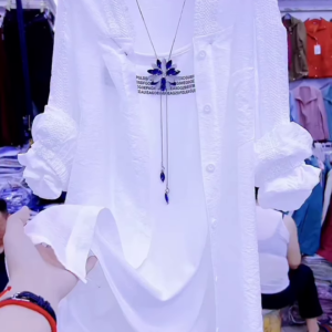 Elegant White Layered Outfit with Striking Blue Necklace