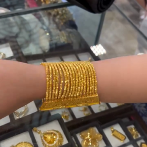 Set of Multiple Ornate Gold Bangles with Intricate Texturing