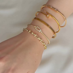 Layered Gold-Toned Bracelet Stack with Cartier Love Inspired Bangle and Knot Design