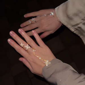 Elegant Gold-Toned Hand Chain Bracelets with Sparkling Floral and Star Accents - Adjustable Finger Rings