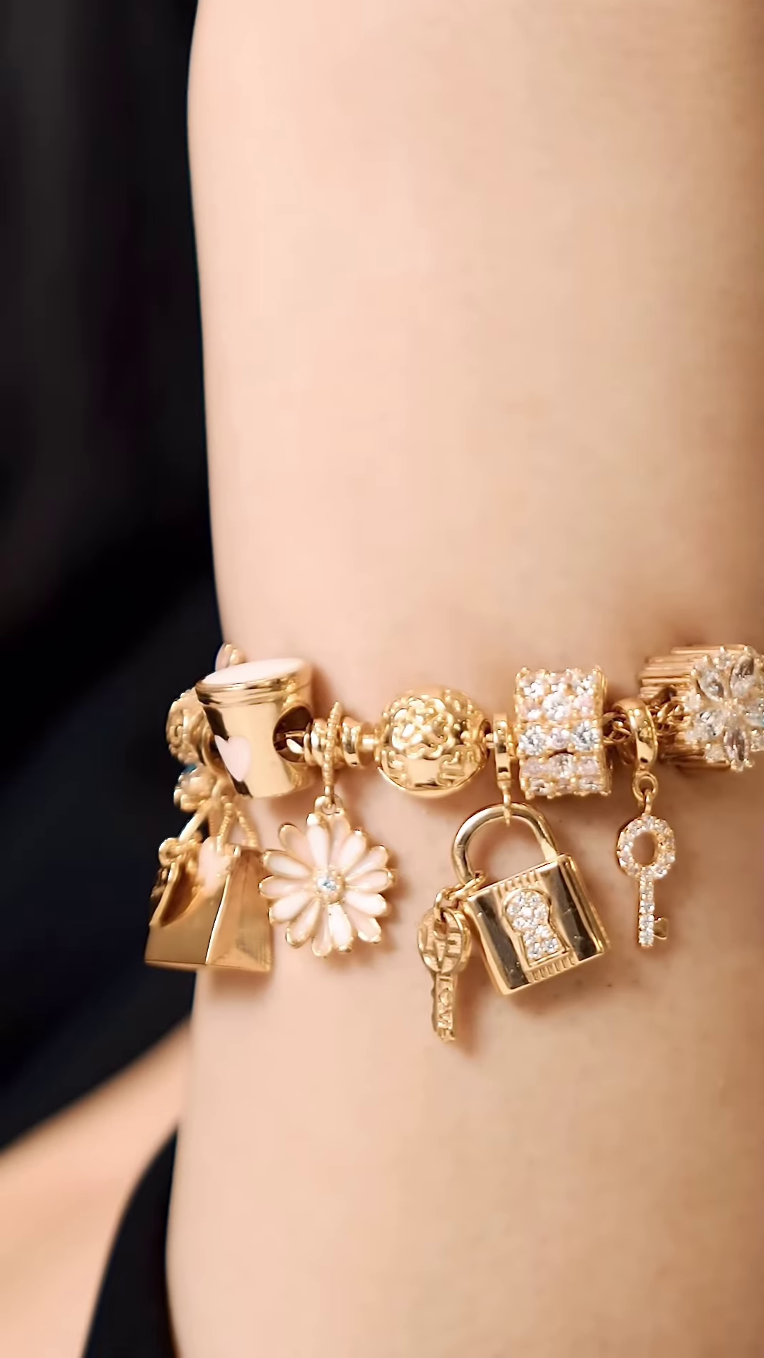 Elegant Gold-Toned Charm Bracelet with Sparkling and Symbolic Charms