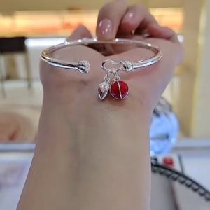 Charming Silver-Toned Bangle Bracelet with Enamel Ladybug and Leaf Charms