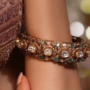 Ornate Gold-Toned Bangle with Kundan, Emerald, and Pearl Detailing