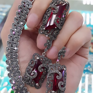 Ornate Oxidized Silver-Toned Jewelry Set with Bold Red Gemstones and Intricate Detailing