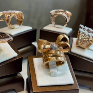 Elegant Gold-Toned Sculptural Bow Ring with Dazzling Clear Gemstone Accents