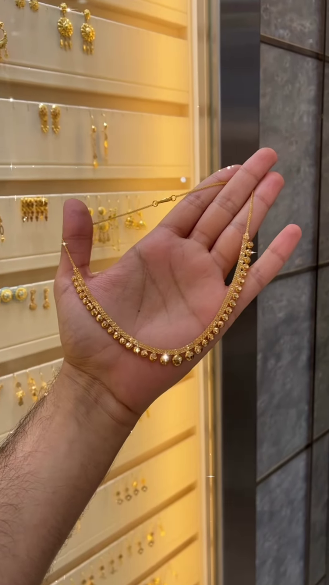 Elegant Gold-Toned Necklace with Spherical Beads and Interwoven Chain Detail - Image 2